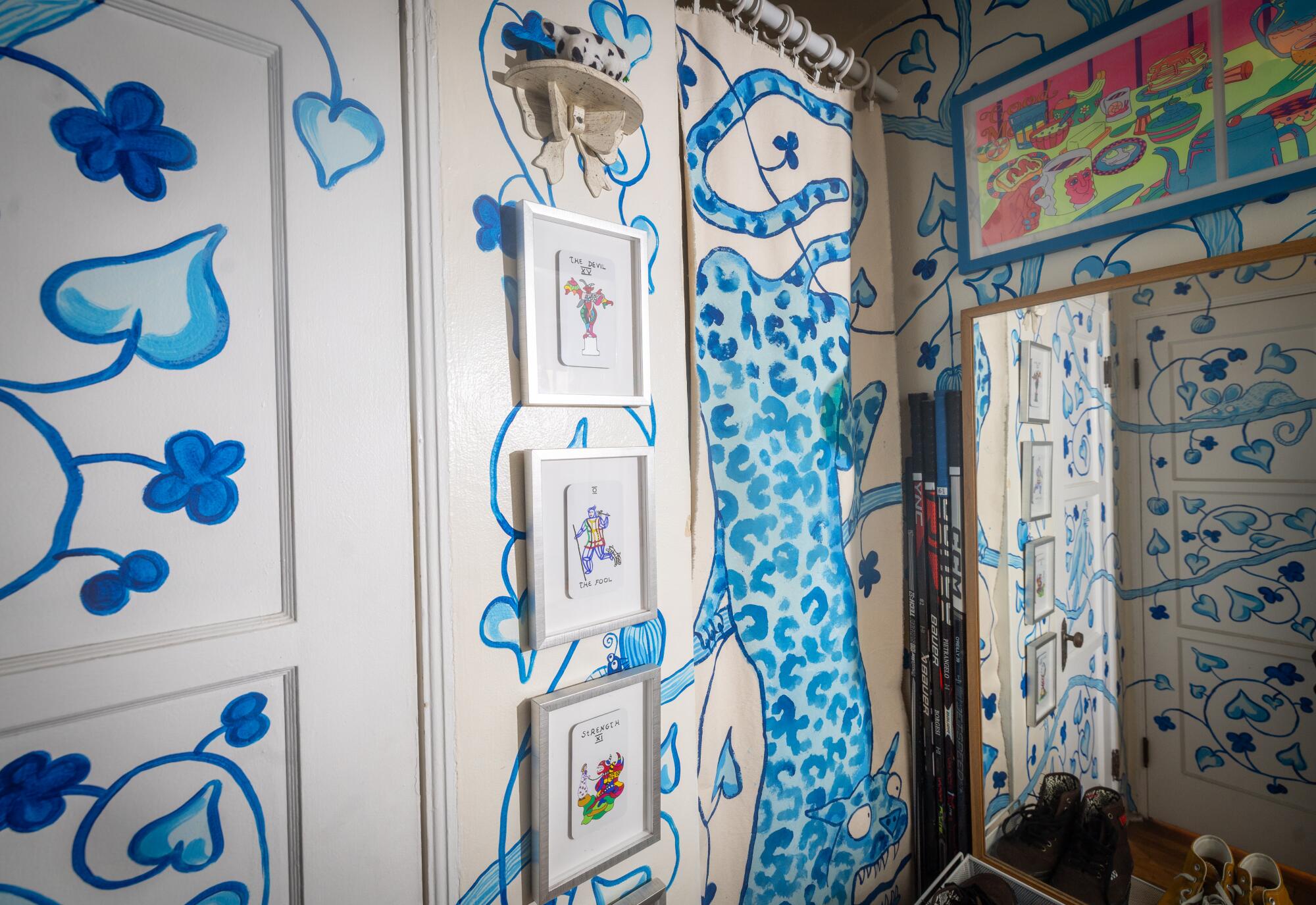 Blue flowers adorn the walls, extending to a blue jaguar on a fabric panel covering a storage area.
