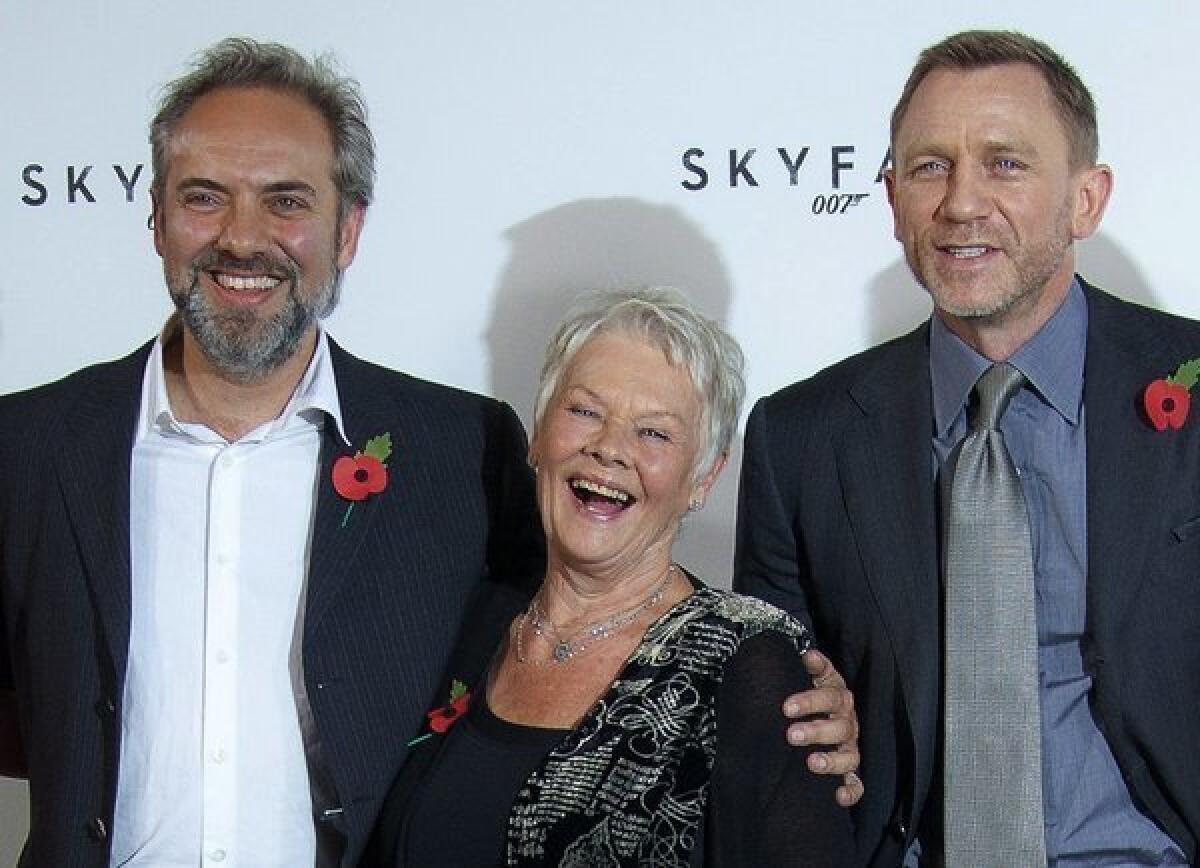 Director Sam Mendes, left, and actors Dame Judi Dench and Daniel Craig at a press event for "Skyfall" in 2011. Mendes says he won't direct the next James Bond film.