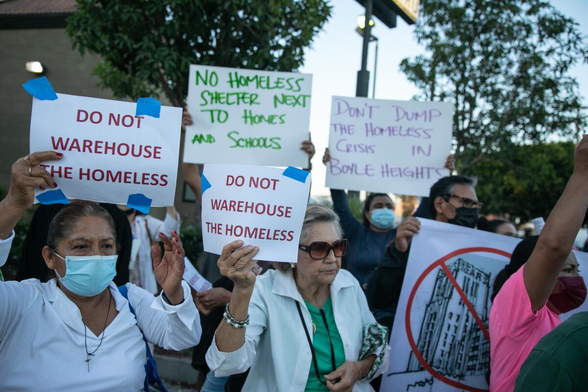 Members of the East Los Angeles Boyle Heights Coalition march in protest of a plan to house homeless at Sears.
