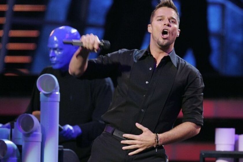 Ricky Martin and Blue Man Group perform during the opening act of the 8th annual Latin Grammy Awards.