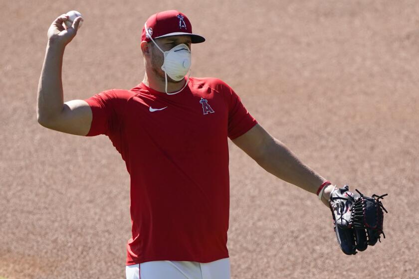 Los Angeles Angels center fielder Mike Trout throws during baseball practice at Angels Stadium on Saturday, July 4, 2020, in Anaheim, Calif. (AP Photo/Ashley Landis)