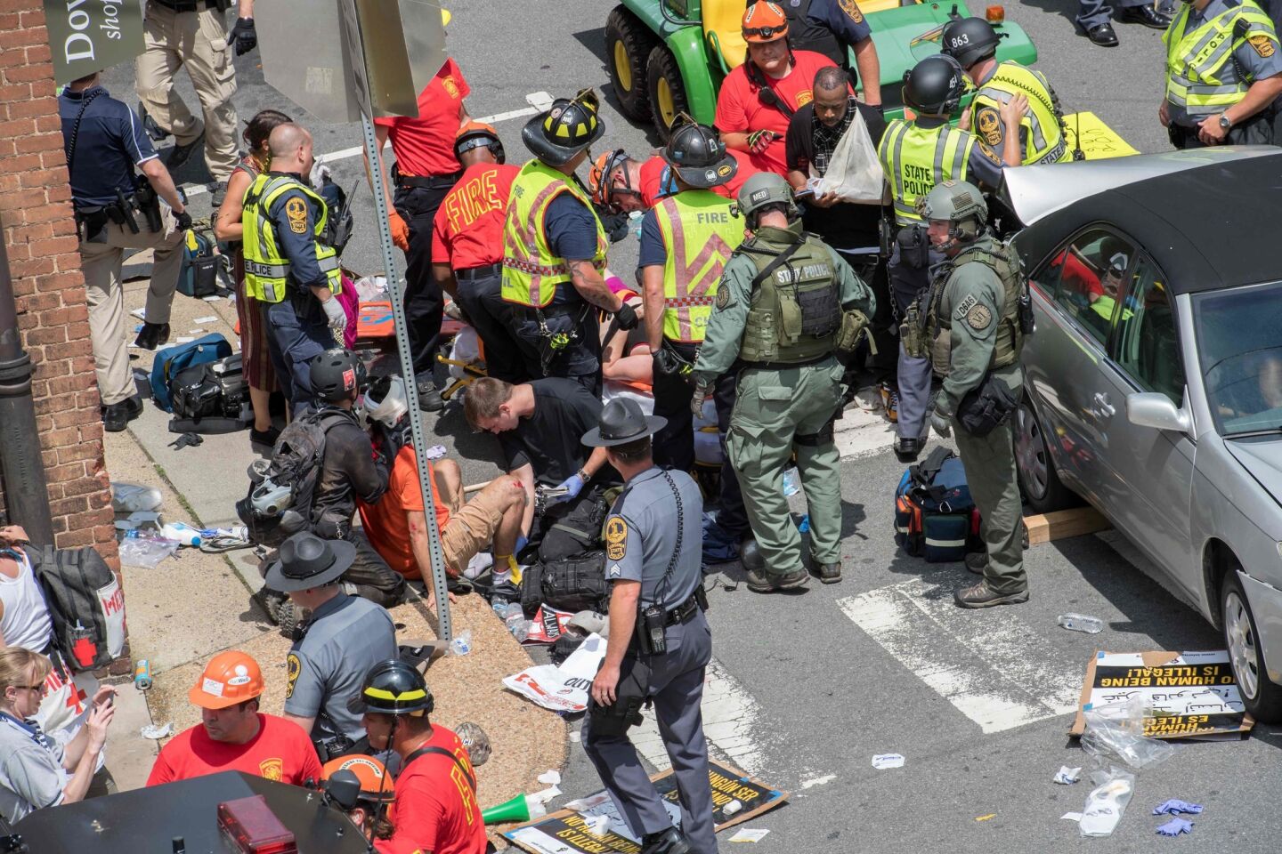 People receive first aid after a car drove into a crowd of protesters in Charlottesville, VA.