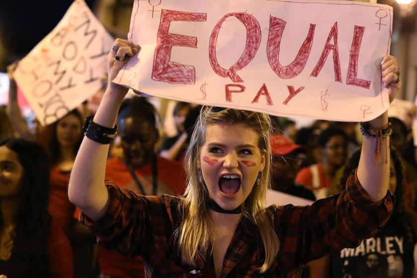 MIAMI, FL - MARCH 08: Clarissa Horsfall holds a sign reading, 'Equal Pay,' as she joins with others during 'A Day Without A Woman' demonstration on March 8, 2017 in Miami, United States. The demonstrators were calling for woman to have equity, justice and human rights for women and all gender-oppressed people. (Photo by Joe Raedle/Getty Images) ** OUTS - ELSENT, FPG, CM - OUTS * NM, PH, VA if sourced by CT, LA or MoD **