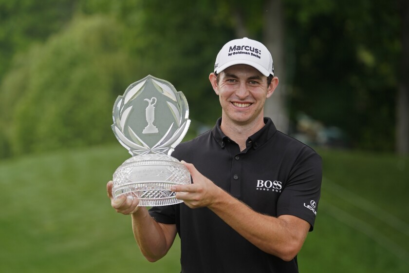 Patrick Cantlay holds the trophy after winning the Memorial golf tournament.