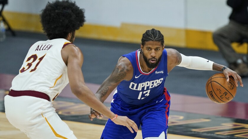 Clippers' Paul George drives to the basket against Cleveland Cavaliers' Jarrett Allen.