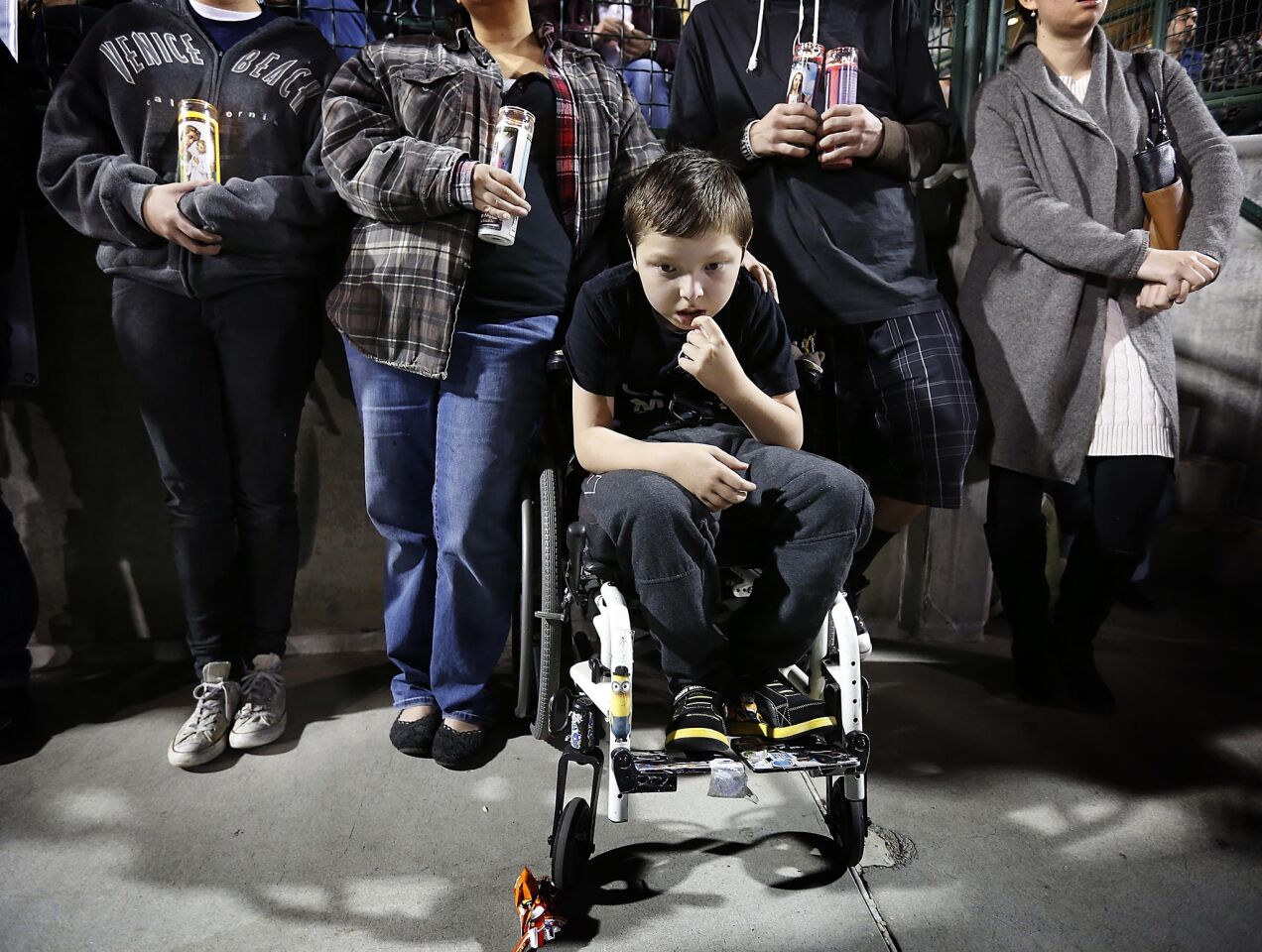 Angel Meler-Baumgartner 11, who was a member of the Inland Regional Center, where the shooting occurred, attends a vigil at San Manuel Stadium for the victims.
