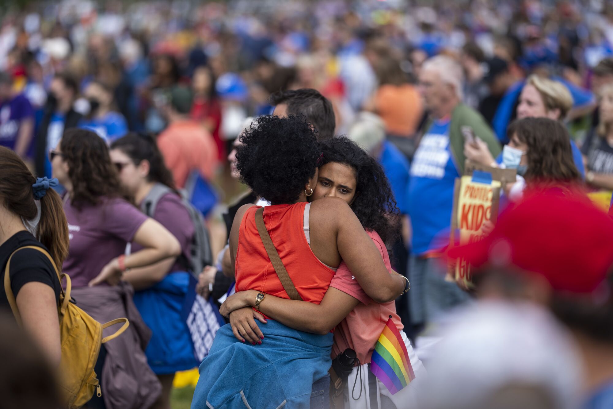 People comfort each other after a man charged the main stage.
