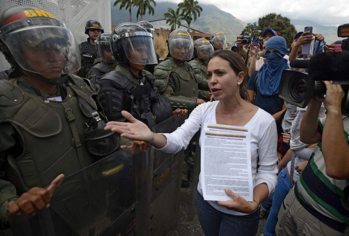 Venezuelan opposition leader Maria Corina Machado talks to members of the national guard during a protest against President Nicolas Maduro in Caracas on March 16, 2014.