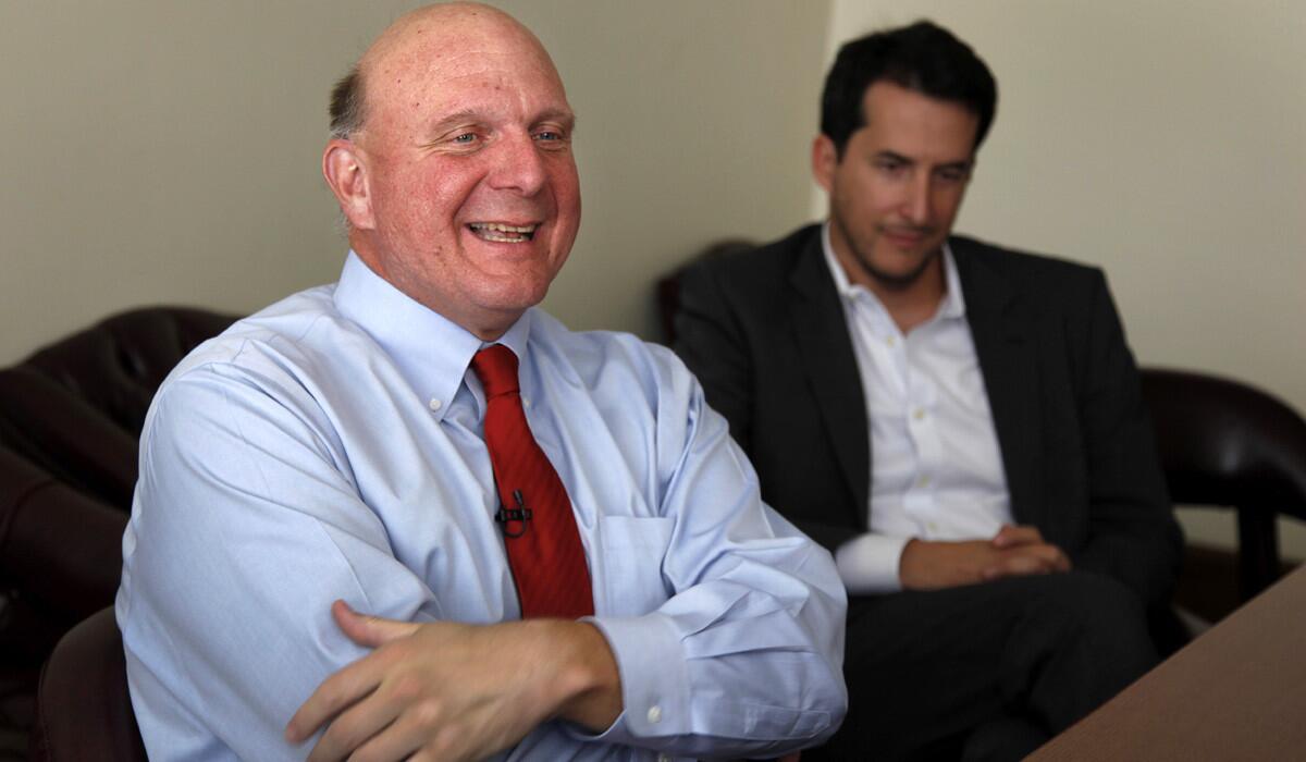 Steve Ballmer, left, talks with a Los Angeles Times reporter before a meeting at City Hall about his pending purchase of the Clippers.