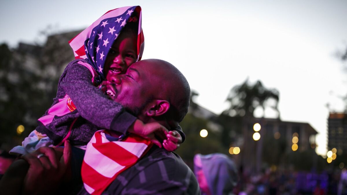 Mike Todd embraces his daughter Maddison during a July Fourth fireworks show at Grand Park in 2016.