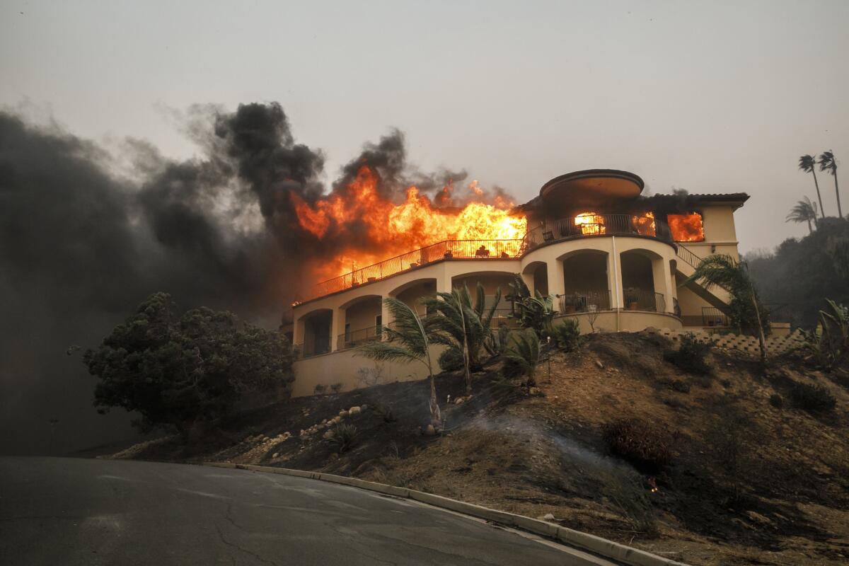 A mansion burns Dec. 5 as a brush fire continues in the Ventura area.