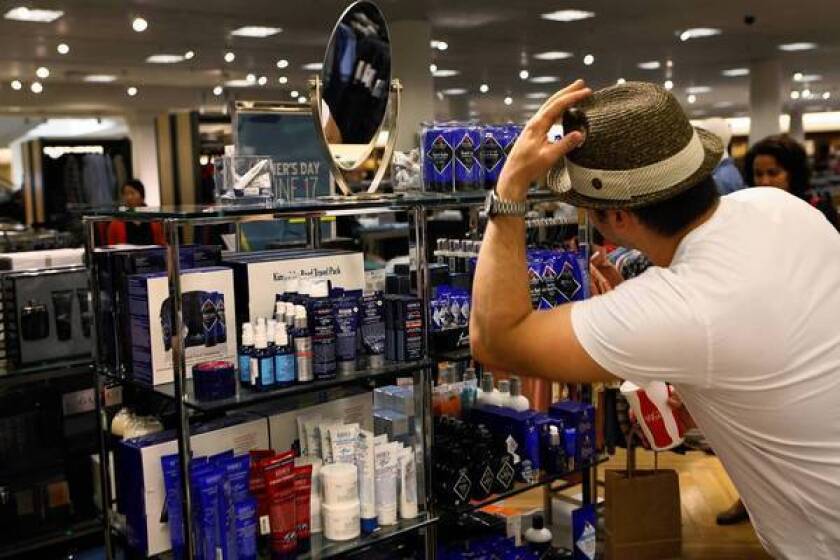Geoff Warner, 38, of Los Angeles checks out his look in Nordstrom at the Grove shopping center. Nordstrom began shifting its male grooming items out of the beauty department last fall and into the men's furnishings area.