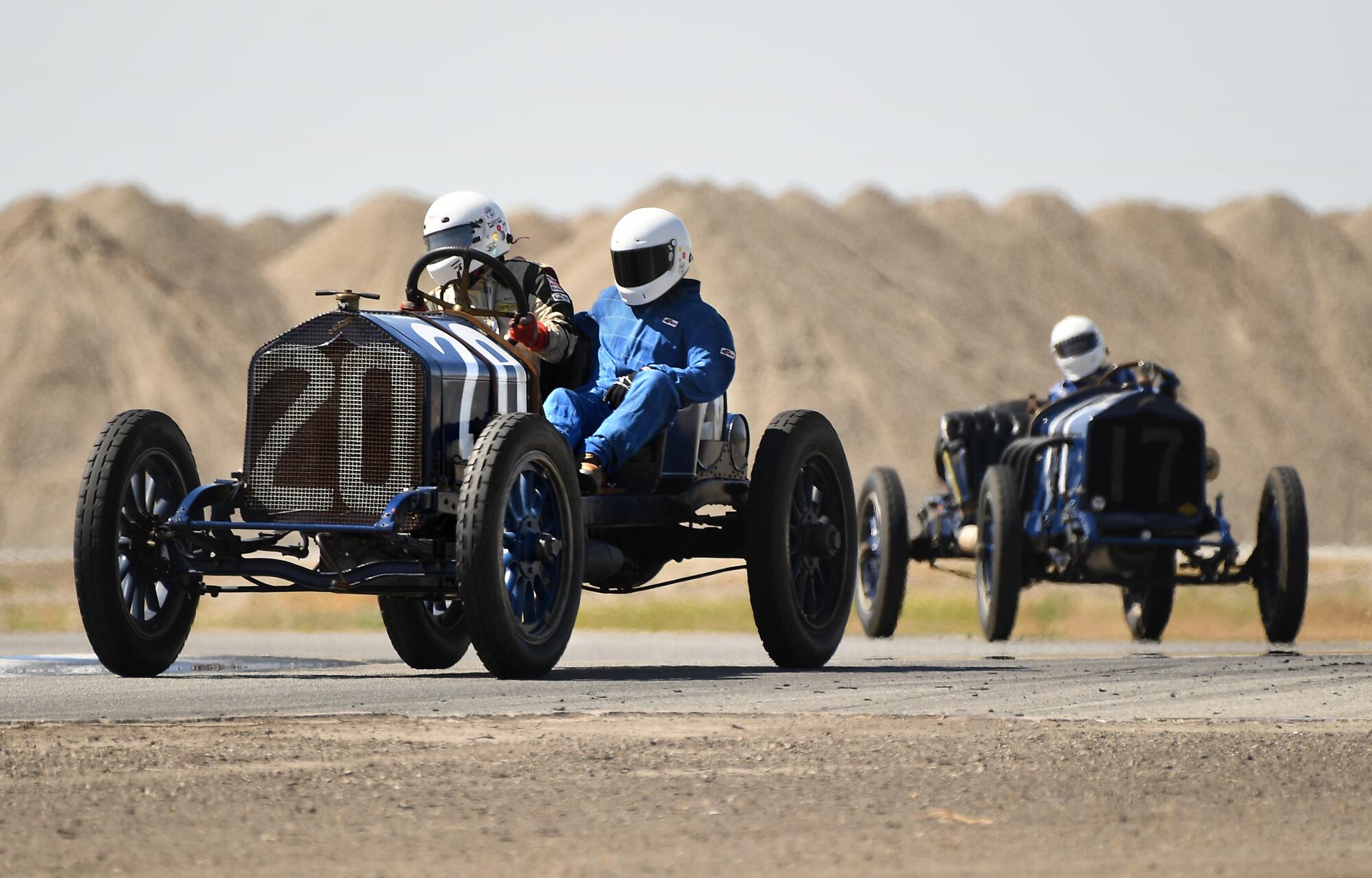 Vintage race cars make their way around the track at Buttonwillow Raceway in Buttonwillow, Calif., on Saturday.