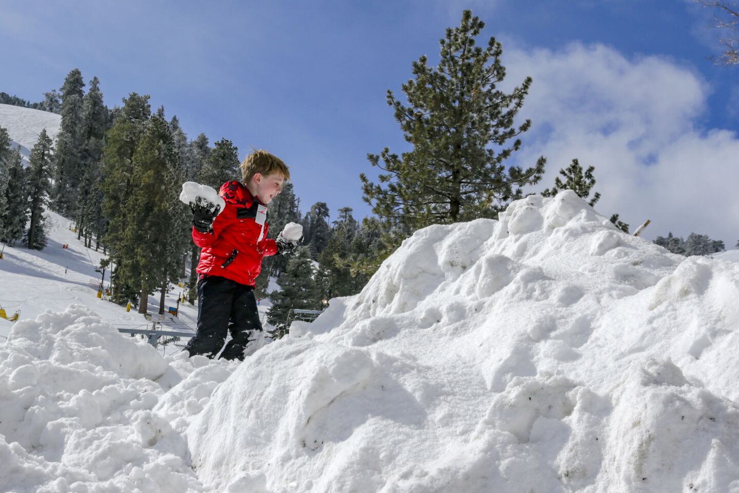 Vince Holliday, 7, of Newport Beach, plays in the snow at Mountain High above Wrightwood.