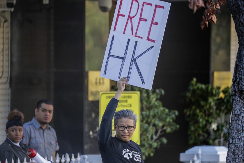 Anh Cao with a "Free Hong Kong" sign at the Chinese Consulate in Los Angeles