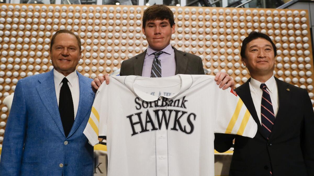 Sports agent Scott Boras, left, SoftBank Hawks pitcher Carter Stewart Jr., center, and Hawks General Manager, Sugihiko Mikasa pose during a news conference in Newport Beach on Thursday.