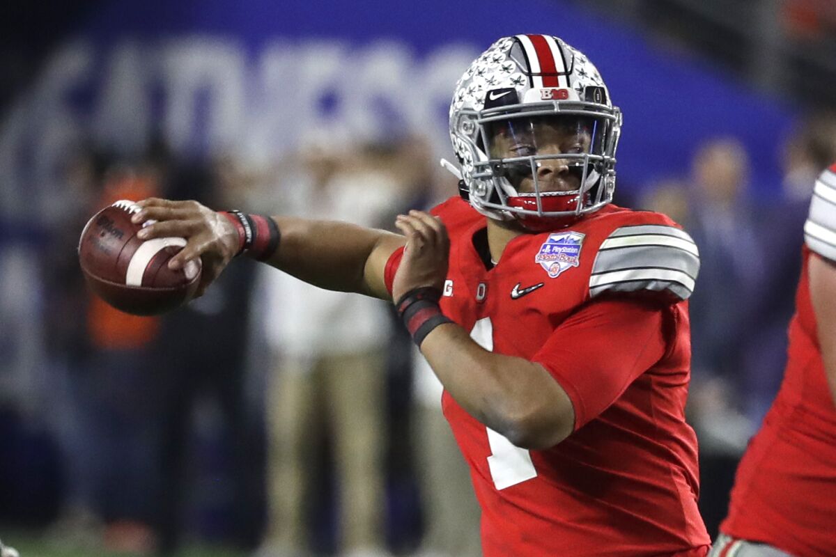 Ohio State quarterback Justin Fields looks to pass during the first half of the Fiesta Bowl against Clemson on Dec. 28