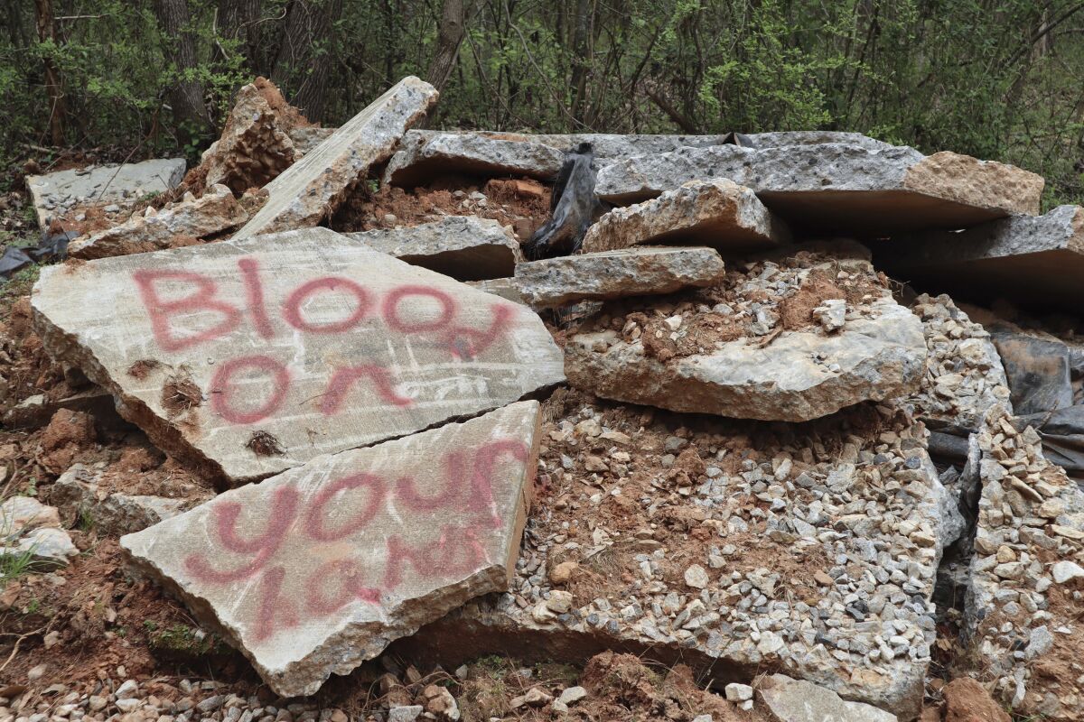 A demolished bike path is shown in the South River Forest near the site of a planned police training center in DeKalb County, Ga., on March 9, 2023. Activists have been protesting the center's planned construction for more than a year, derisively calling it "Cop City." (AP Photo/R.J. Rico)