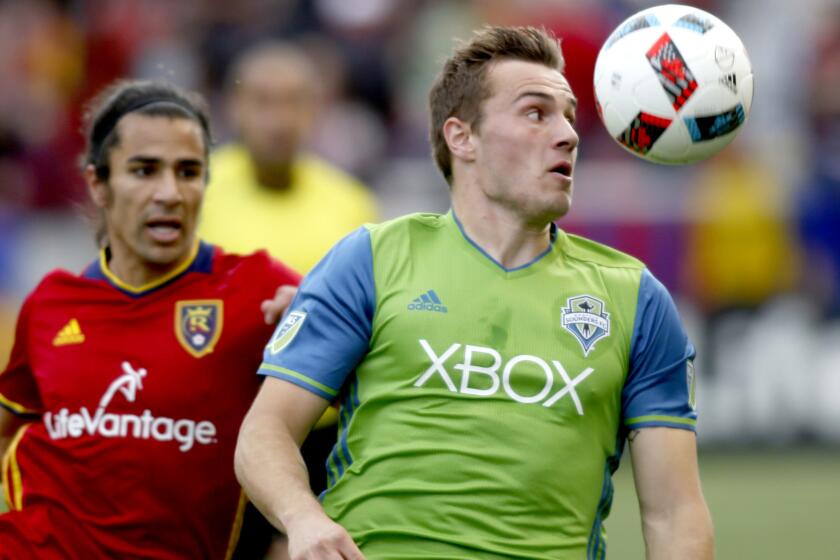 Seattle's Jordan Morris, right, tries to track down a pass against Real Salt Lake's Tony Beltran during an MLS game March 12.
