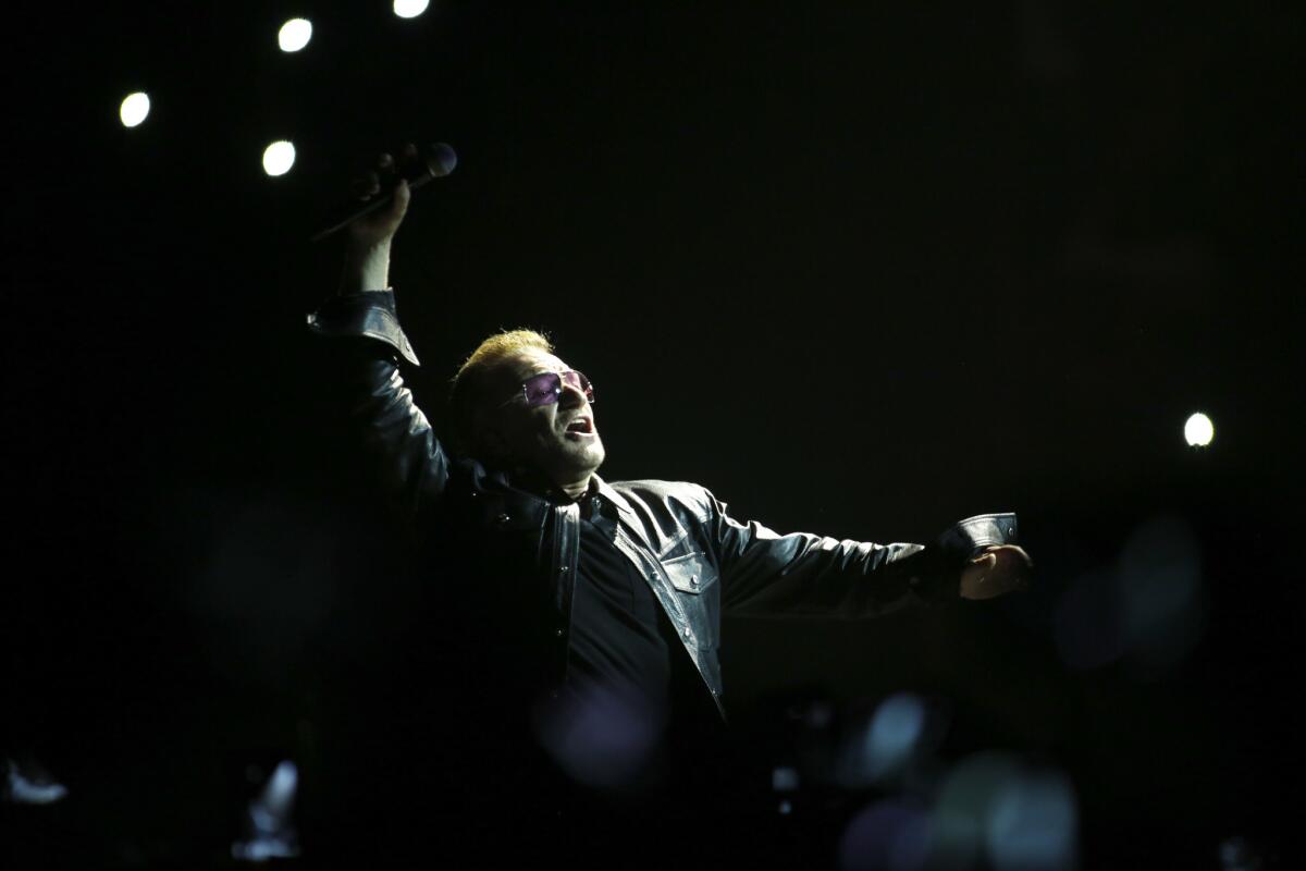 U2's Bono greets the audience at the Forum in 2014.