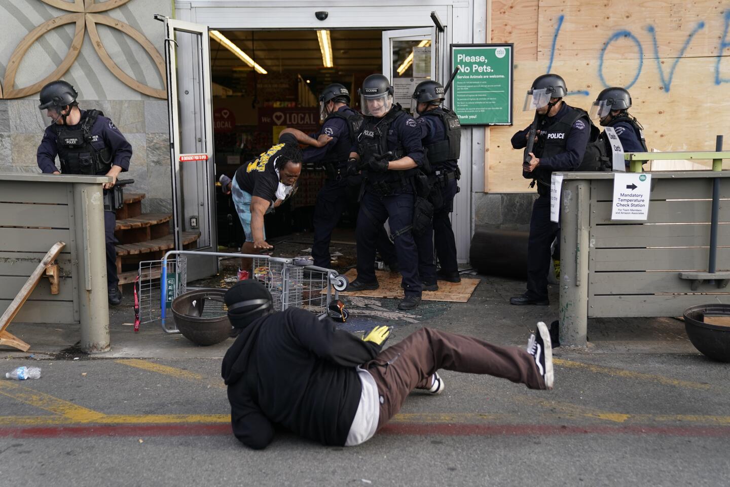 Police arrest looters at Whole Foods Market in the Fairfax District on Saturday in Los Angeles