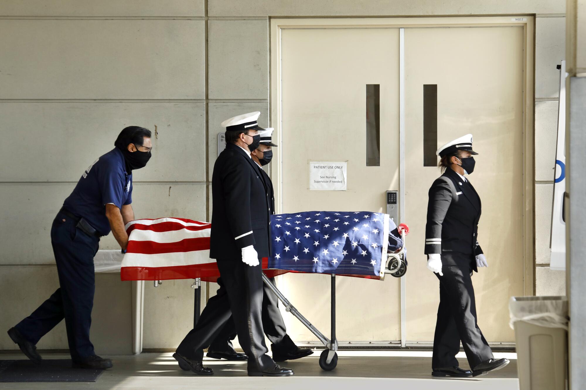 The body of veteran Los Angeles County firefighter Jonathan Flagler is transported to the coroner's van.