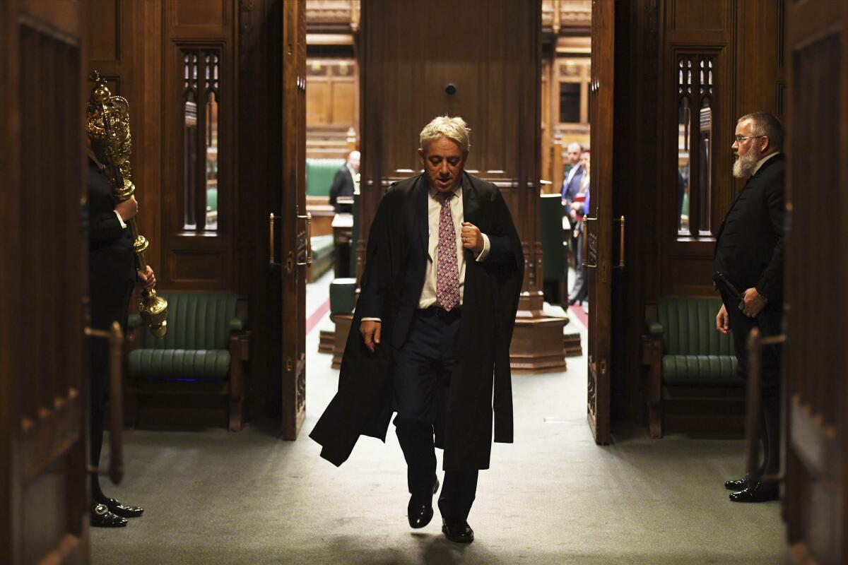 Speaker John Bercow leaves the British House of Commons on Oct. 31, 2019. The lower house speaker, who has become a global celebrity and online meme-magnet for his loud ties, even louder voice and star turn at the center of Britain's Brexit drama, stepped down on Oct. 31 after 10 years in the job.