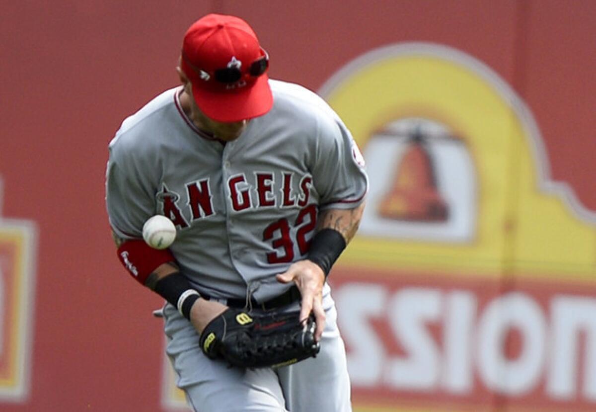 Angels outfielder Josh Hamilton misses a fly ball in the eighth inning of a game against the Texas Rangers in April.