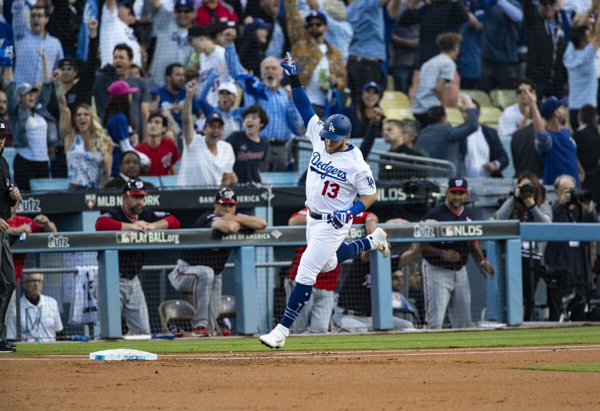 Dodgers first baseman Max Muncy celebrates after hitting a two-run home run in the first inning against the Washington Nationals in Game 5 of the NLDS.