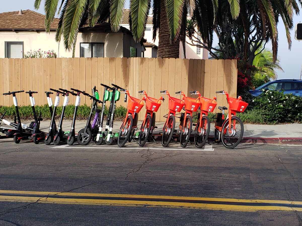 A scooter corral in north Pacific Beach includes Bird and Lime scooters, and Jump bikes. Jump’s parent company, Uber, announced it would be removing its bikes and scooters from San Diego.