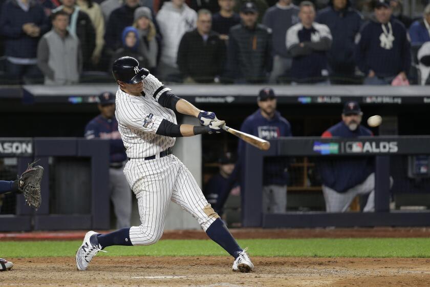 New York Yankees' DJ LeMahieu connects for a three-run double to left field against the Minnesota Twins during the seventh inning of Game 1 of an American League Division Series baseball game, Friday, Oct. 4, 2019, in New York. (AP Photo/Seth Wenig)