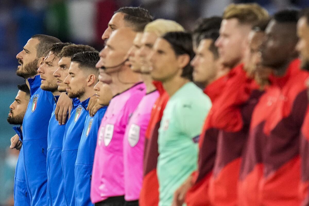 Italy players, left, and Switzerland  