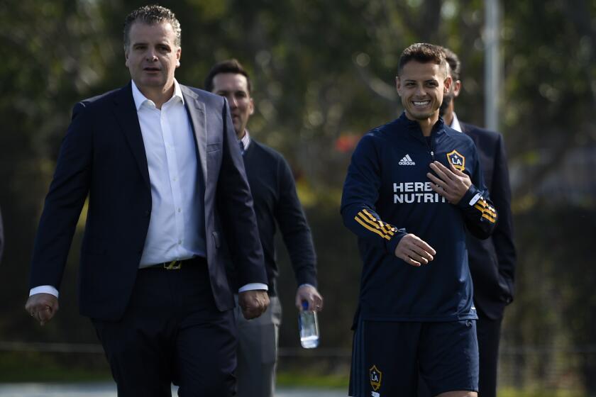 Los Angeles Galaxy's Javier "Chicharito" Hernández, right, walks to the practice field with general manager Dennis te Kloese for an MLS soccer training session in Carson, Calif., Thursday, Jan. 23, 2020. (AP Photo/Kelvin Kuo)