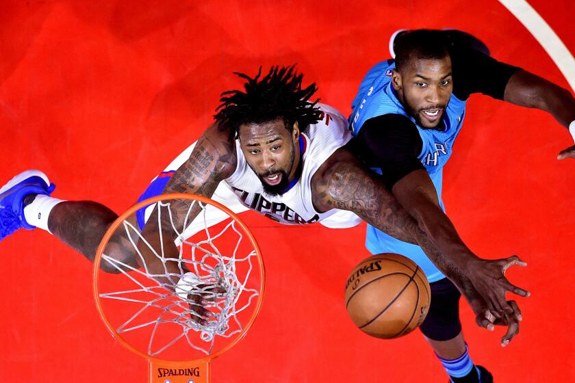 Clippers center DeAndre Jordan, left, and Hornets forward Michael Kidd-Gilchrist battle for a rebound during the first half of their game Sunday.