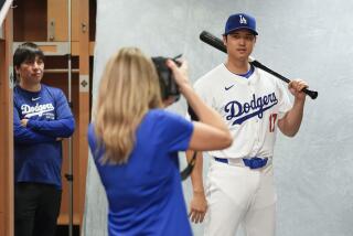 Dodgers Shohei Ohtani poses for a portrait during a spring training team photo day at Camelback Ranch in Phoenix.