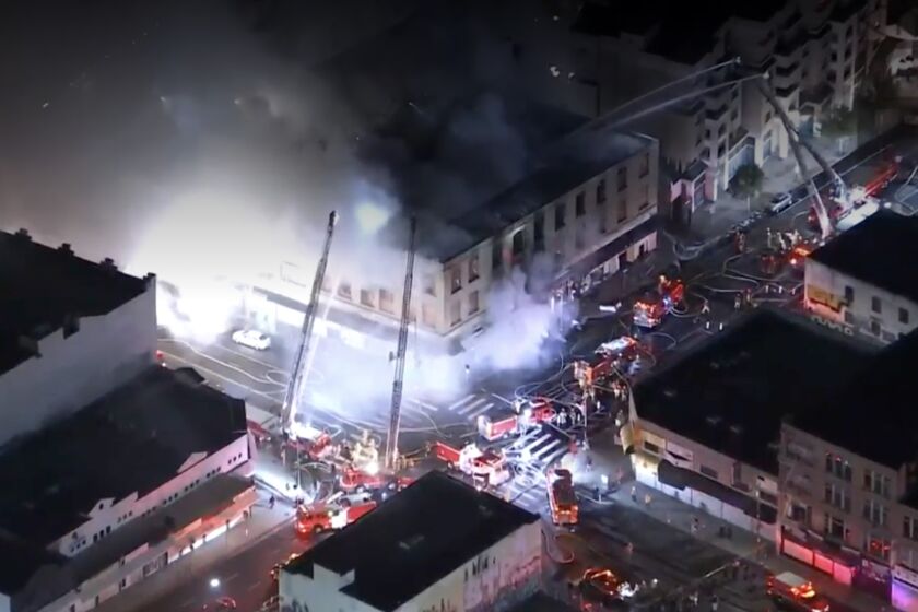 Los Angeles Fire Department firefighters battle a fire at a boarded-up three-story commercial building in downtown Los Angeles, on Wednesday October 26, 2022.