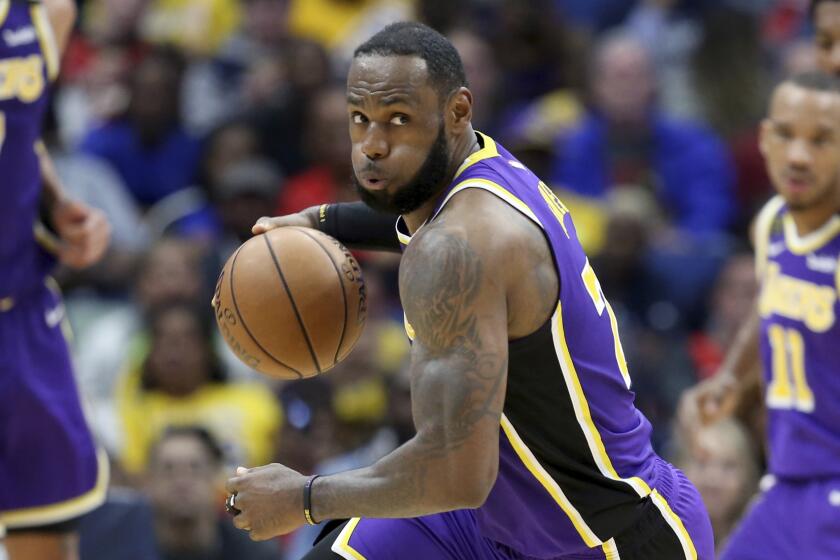 Los Angeles Lakers forward LeBron James (23) looks dribbles the ball in the first half of an NBA basketball game against the Los Angeles Lakers in New Orleans, Sunday, March 1, 2020. (AP Photo/Rusty Costanza)