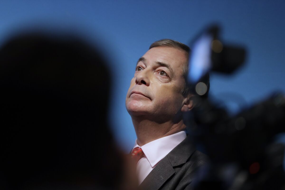FILE - In this Friday, Nov. 22, 2019 file photo, Nigel Farage, Leader of Britain's Brexit Party, takes his seat after speaking on stage at the launch of the party's policies for the General Election campaign, in London. GB News, a British news channel that has had a rocky start since launching last month as a right-leaning alternative to the BBC and Sky News, said Saturday, July 17, 2021 it has recruited populist politician Nigel Farage as a presenter. (AP Photo/Kirsty Wigglesworth, File)