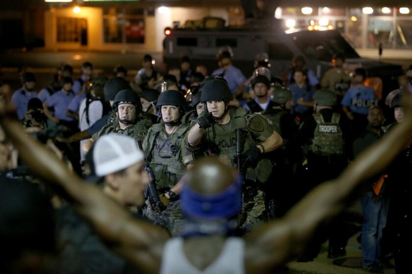 Police face off with demonstrators Aug. 19 in Ferguson, Mo.