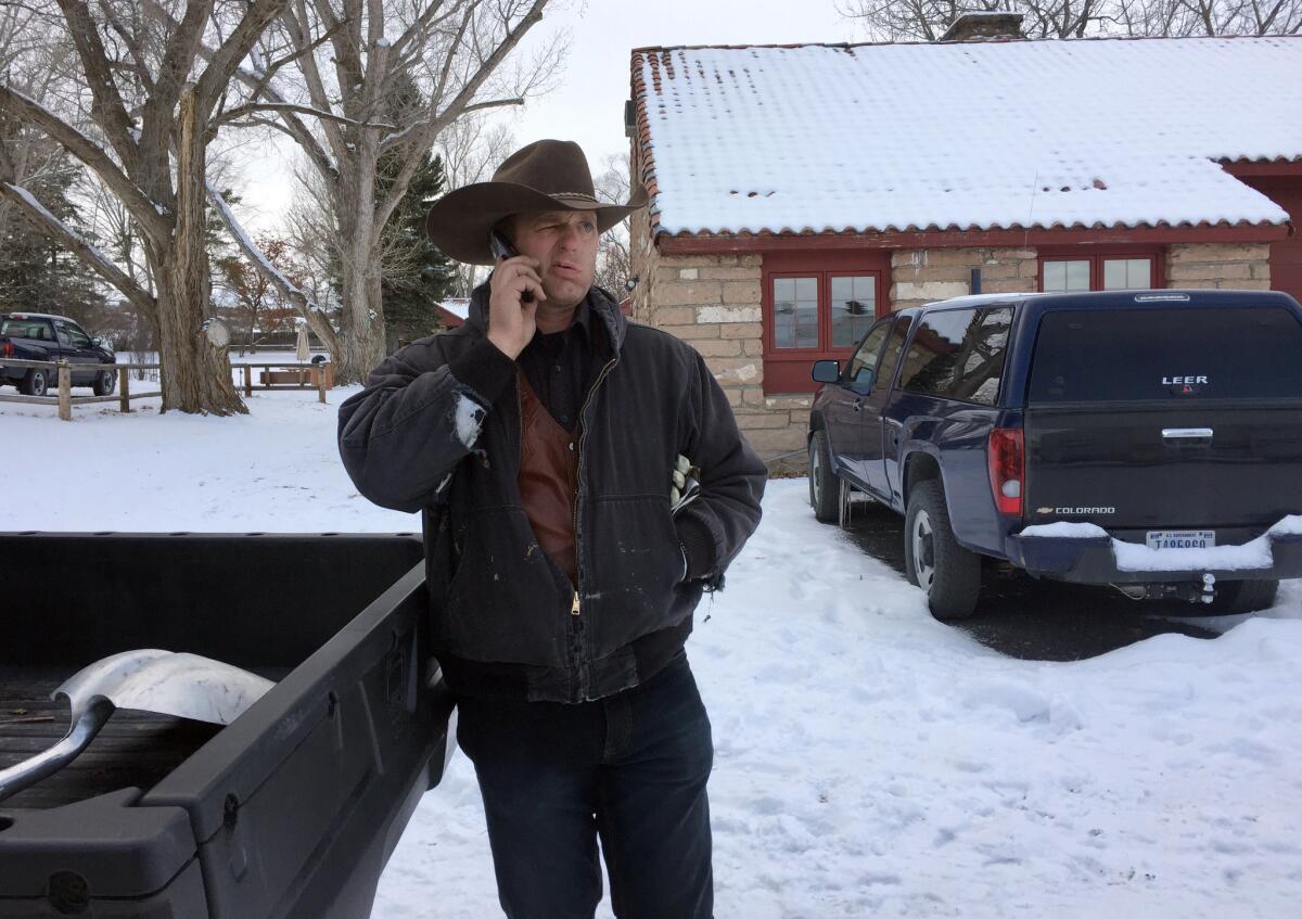 Ryan Bundy talks on the phone at the Malheur National Wildlife Refuge near Burns, Ore. Bundy is one of the protesters occupying the refuge to object to a prison sentence for local ranchers for burning federal land.