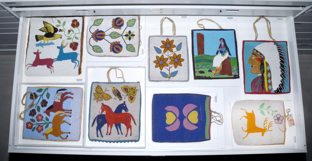 Beaded pouches bearing designs of deer, horses and flowers are seen tidily arranged in a drawer.