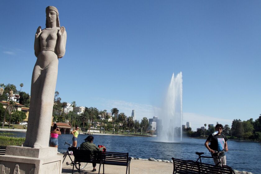The statue known as the Lady of the Lake is actually titled "Nuestra Reina de Los Angeles." She stands watch as visitors return to the newly renovated park.