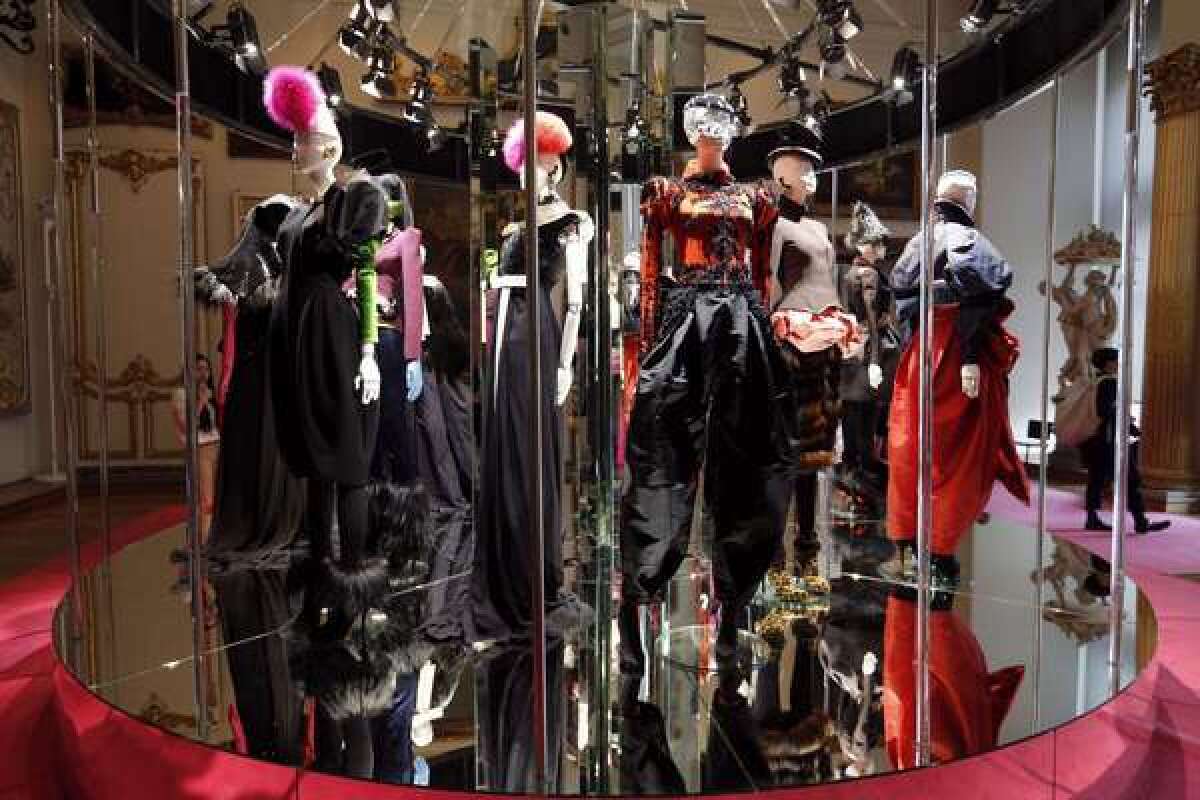 Creations by French designer Christian Lacroix to celebrate the spirit of Elsa Schiaparelli are displayed on a mirrored carousel.