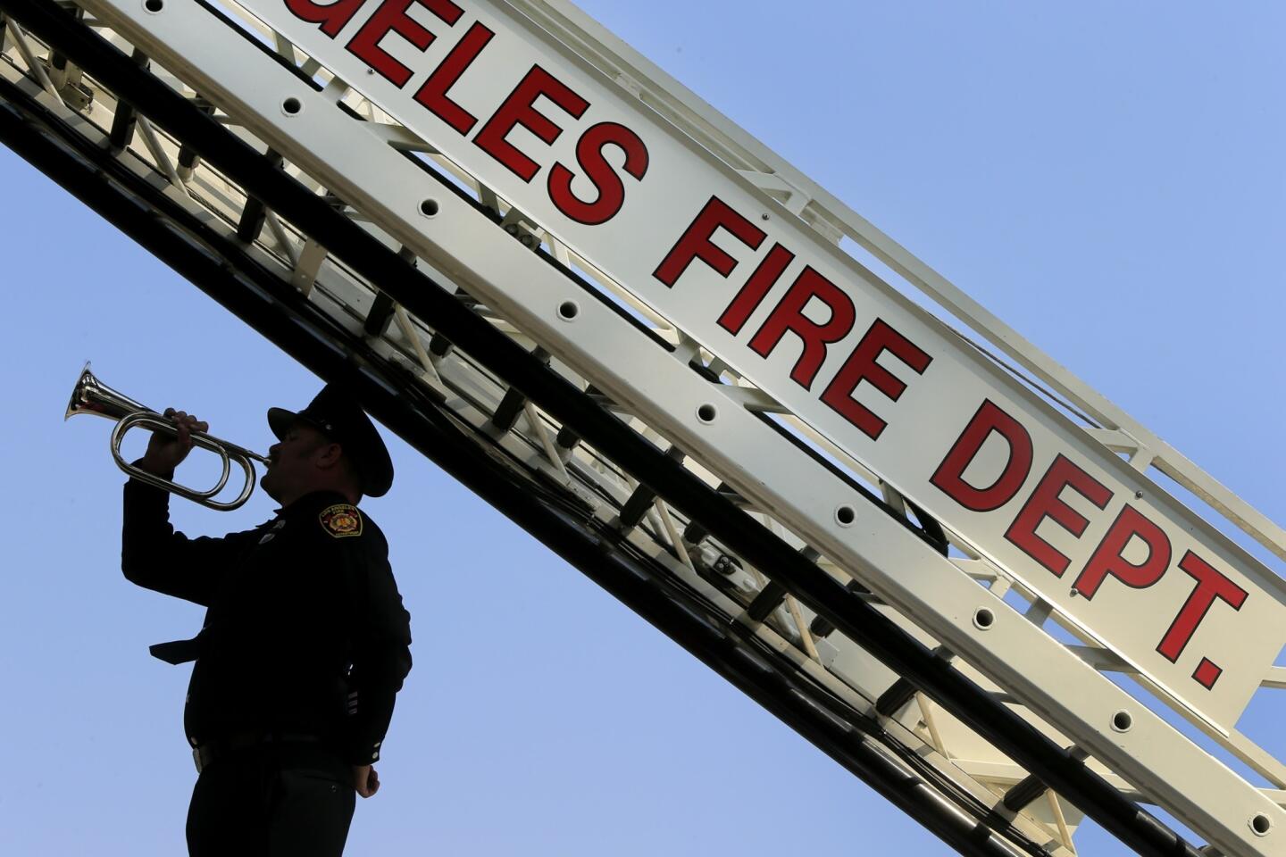 Los Angeles firefighter Dustin Clark plays taps at the end of a Sept. 11 remembrance ceremony.