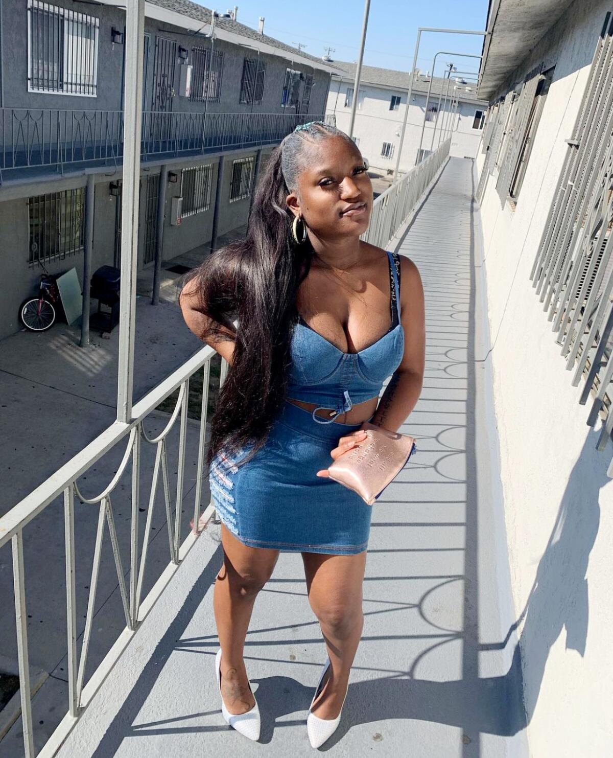 Asherey Ryan poses for a photo outside an apartment.