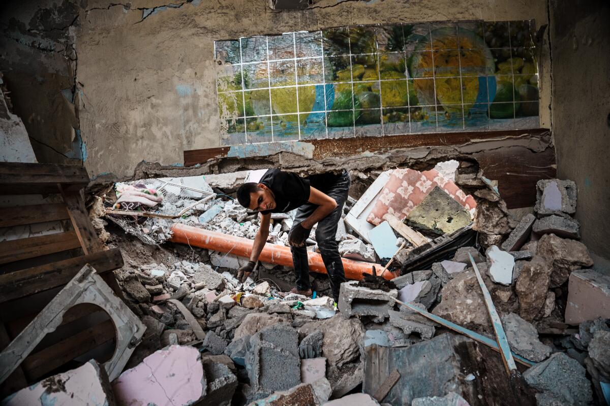 Local residents examine the aftermath of an Israeli airstrike on the Al Ansar Mosque in the occupied West Bank.