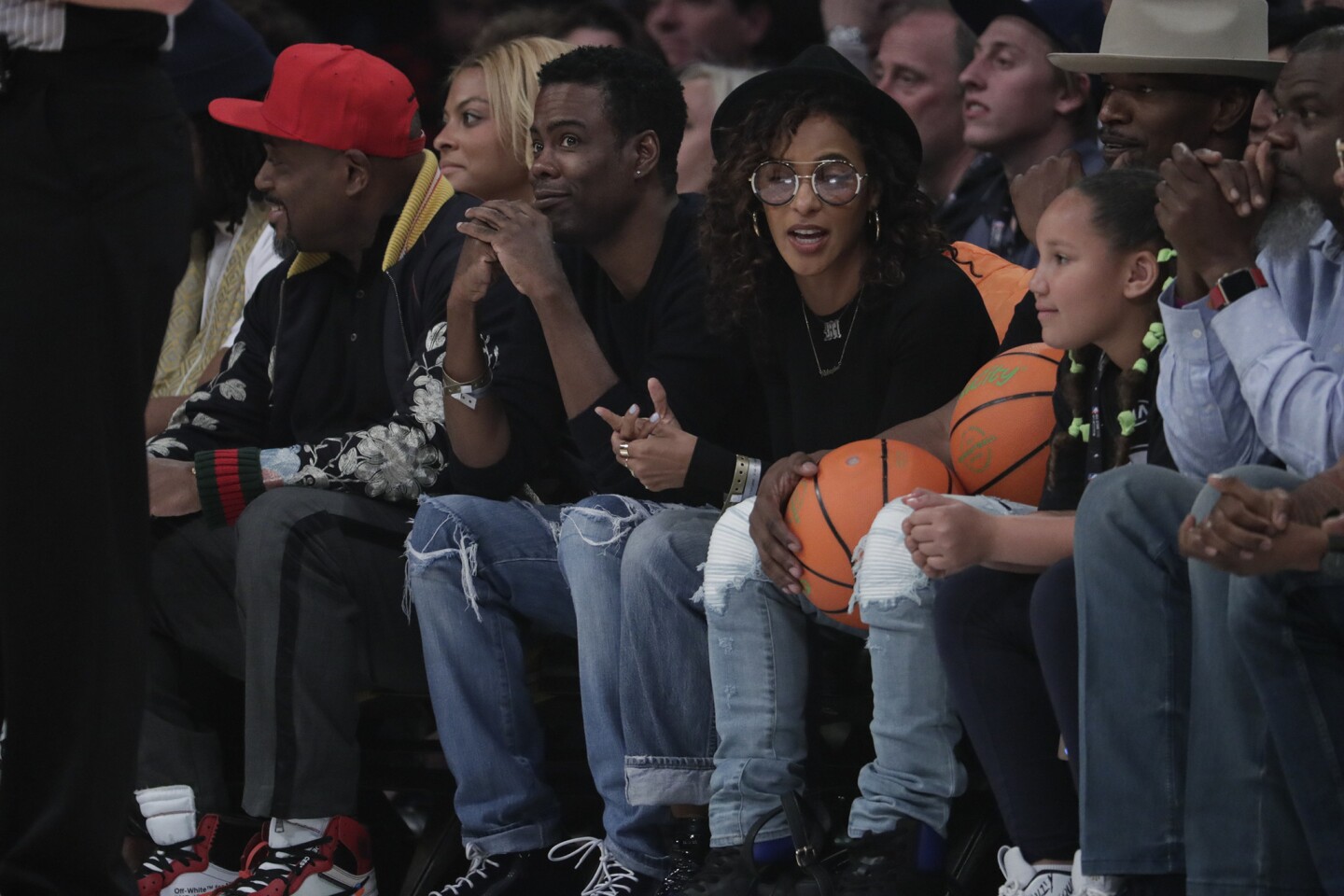 Chris Rock sits courtside at the NBA All Star game at Staples Center.