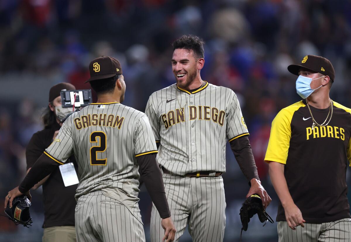 Joe Musgrove celebrates with Trent Grisham after pitching no-hitter against the Texas Rangers at Globe Life Field on Friday.