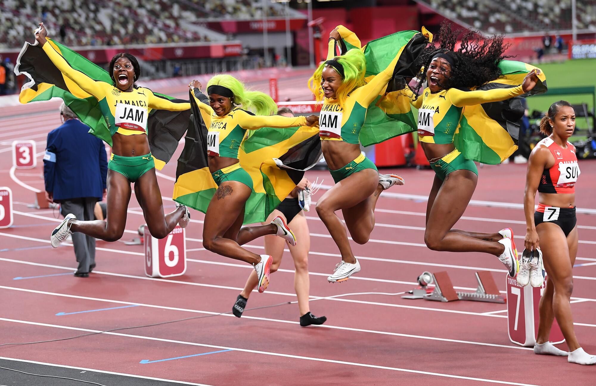 Members of Jamaica women's 400 relay team celebrate after winning the gold medal.