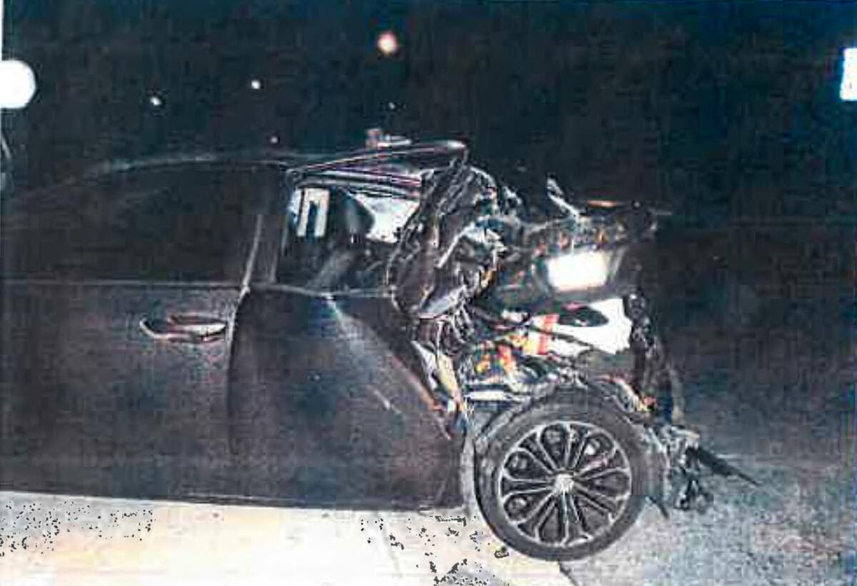A car with heavy damage to the rear